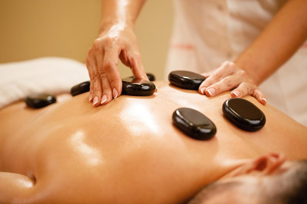 Massage Center Multan – Enjoy a relaxing hot stone therapy session for deep muscle relaxation and stress relief.